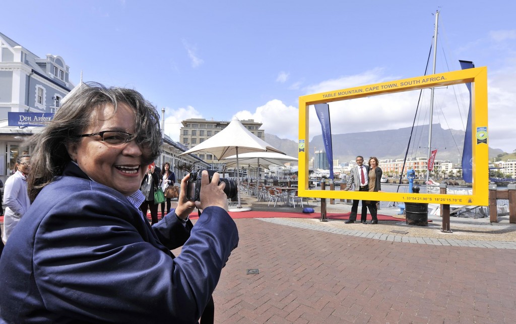 Cape Town Mayor Patricia de Lille in the foreground with Table Mountain in the background, as seen through the New7Wonders legacy picture frame on the V&A Waterfront.